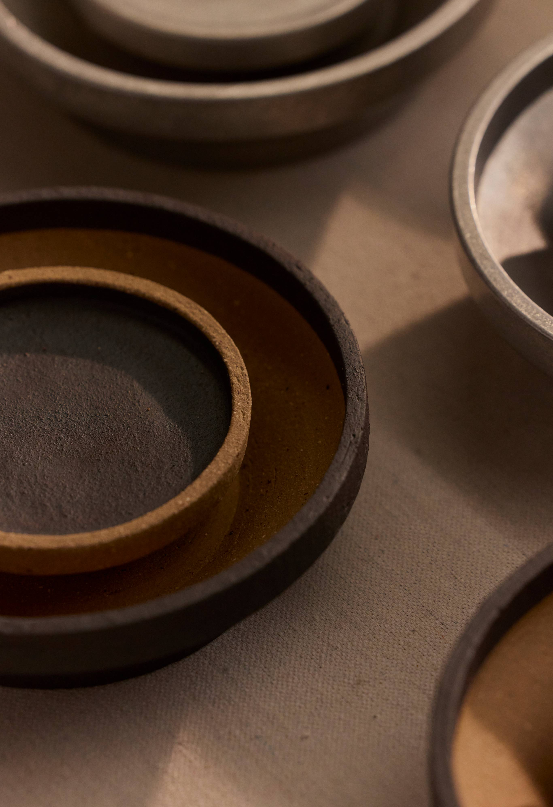 A close up detail of the mid-fire clay Chorus Wall Light.
