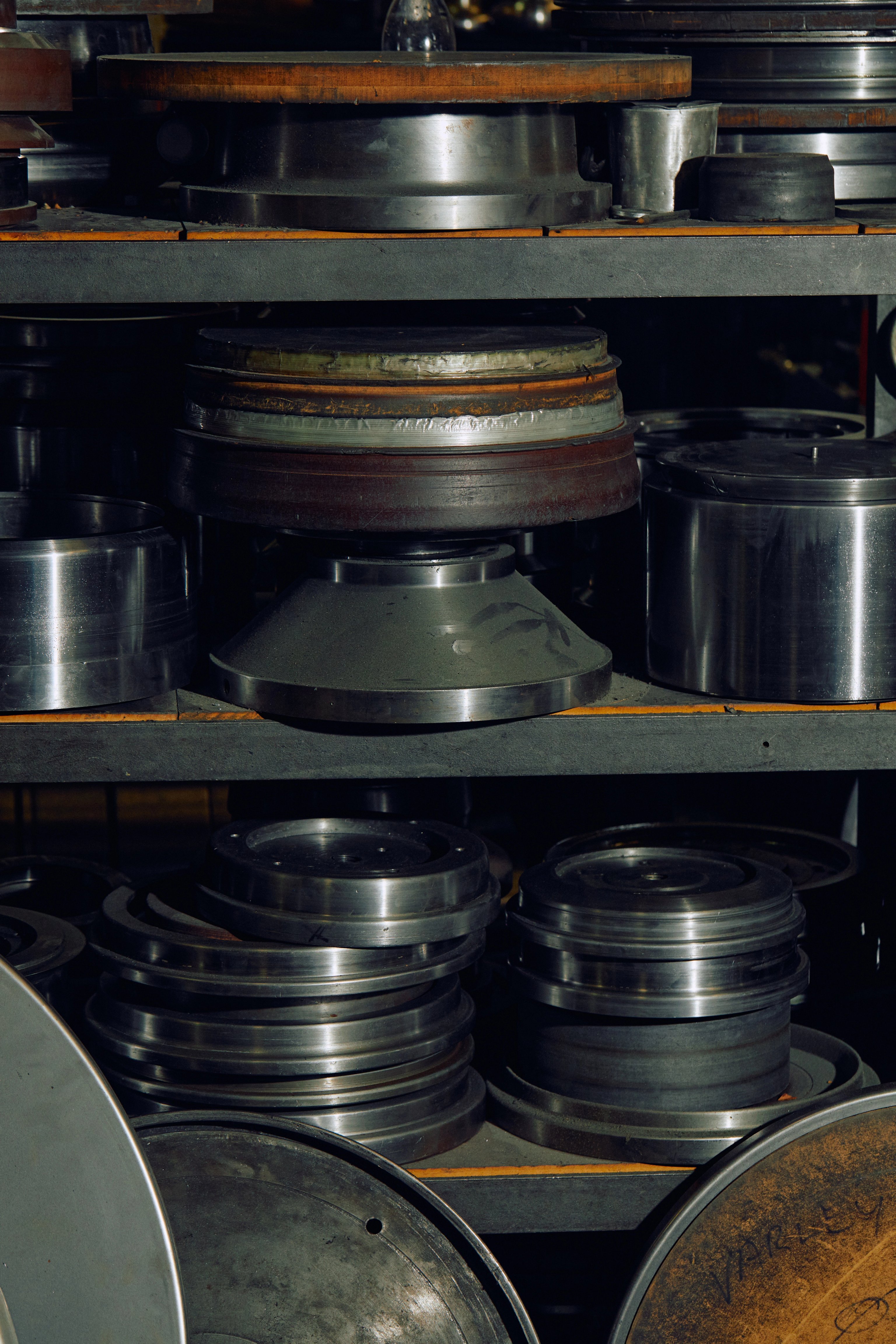 A shelf full of metal jigs and tools for spinning metal