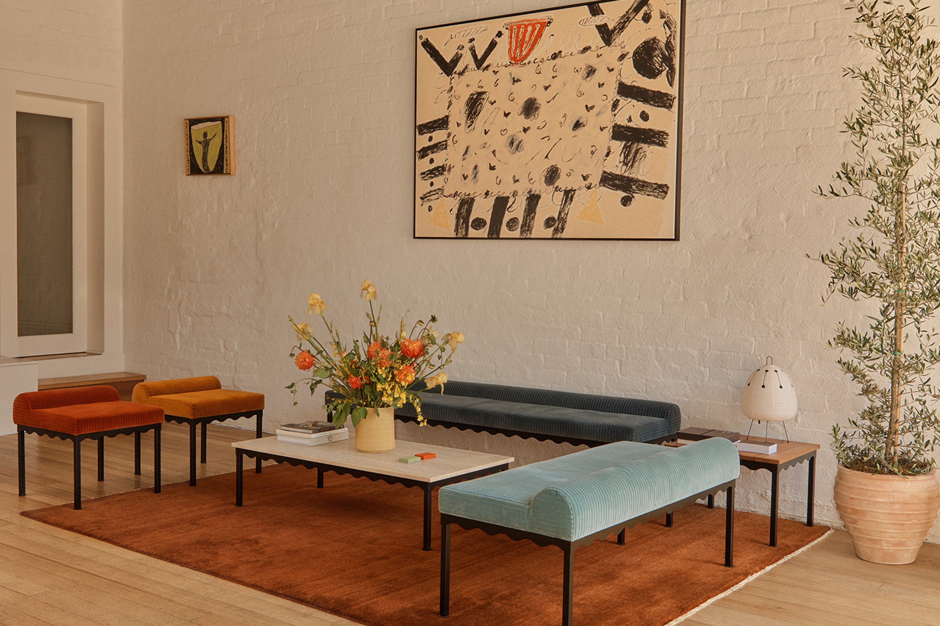 Coco Flip's Bellini Collection. Four upholstered benches with light blue, dark blue, red and yellow corduroy fabric and black steel frames