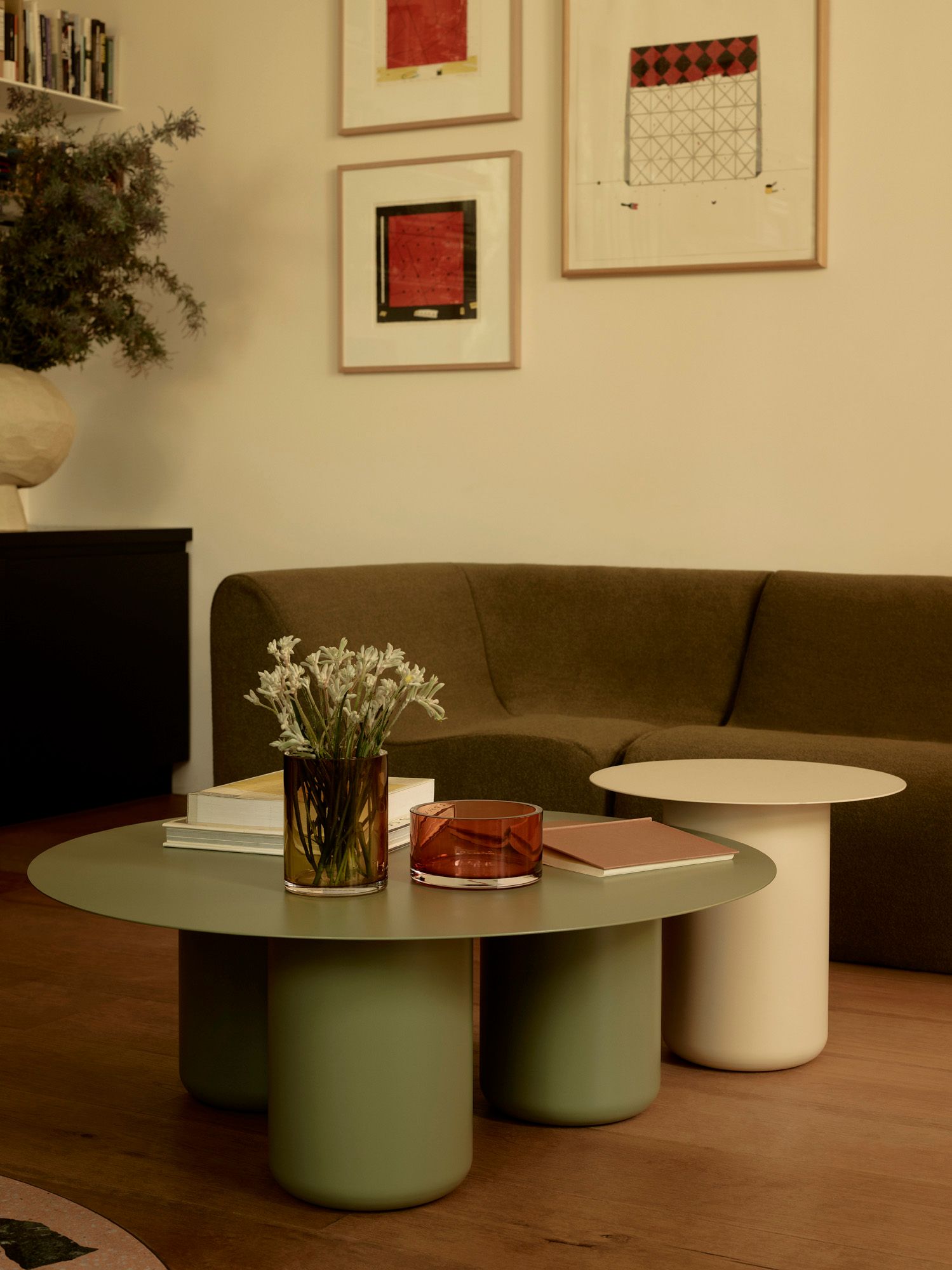 Green and Paperbark Coffee and Side Tables in a room with warm tones and a green sofa.