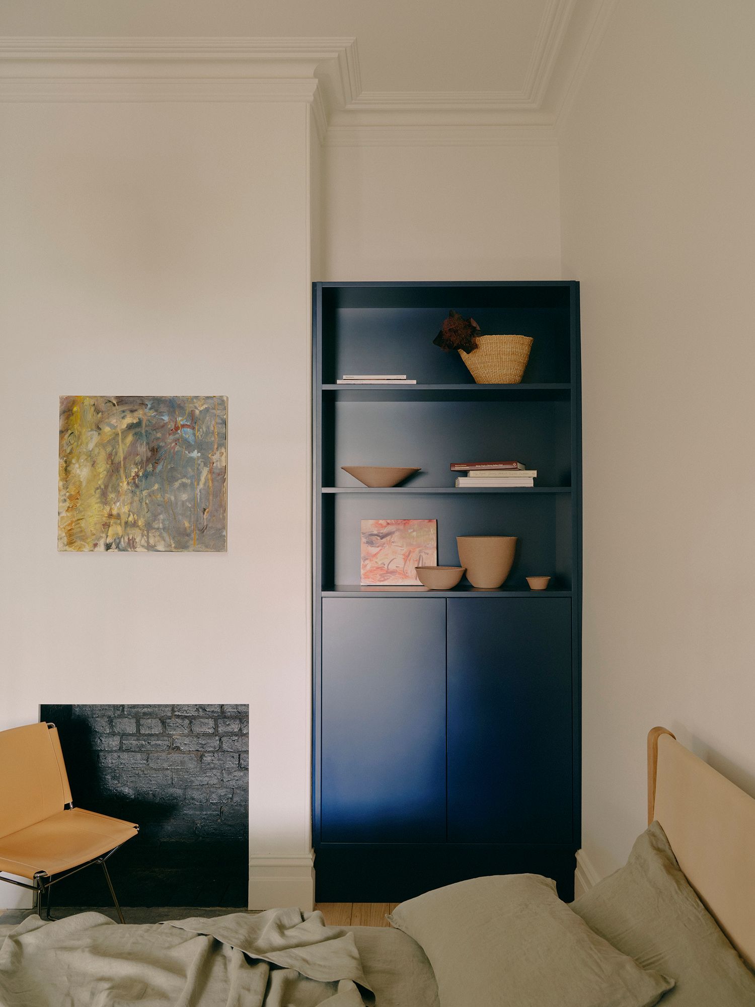 A bedroom with deep blue custom joinery