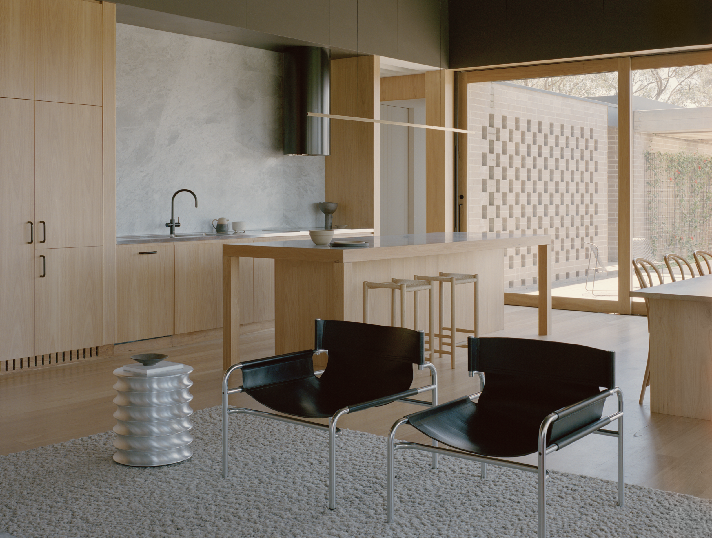 Living room with natural materials and warm neutral furniture.