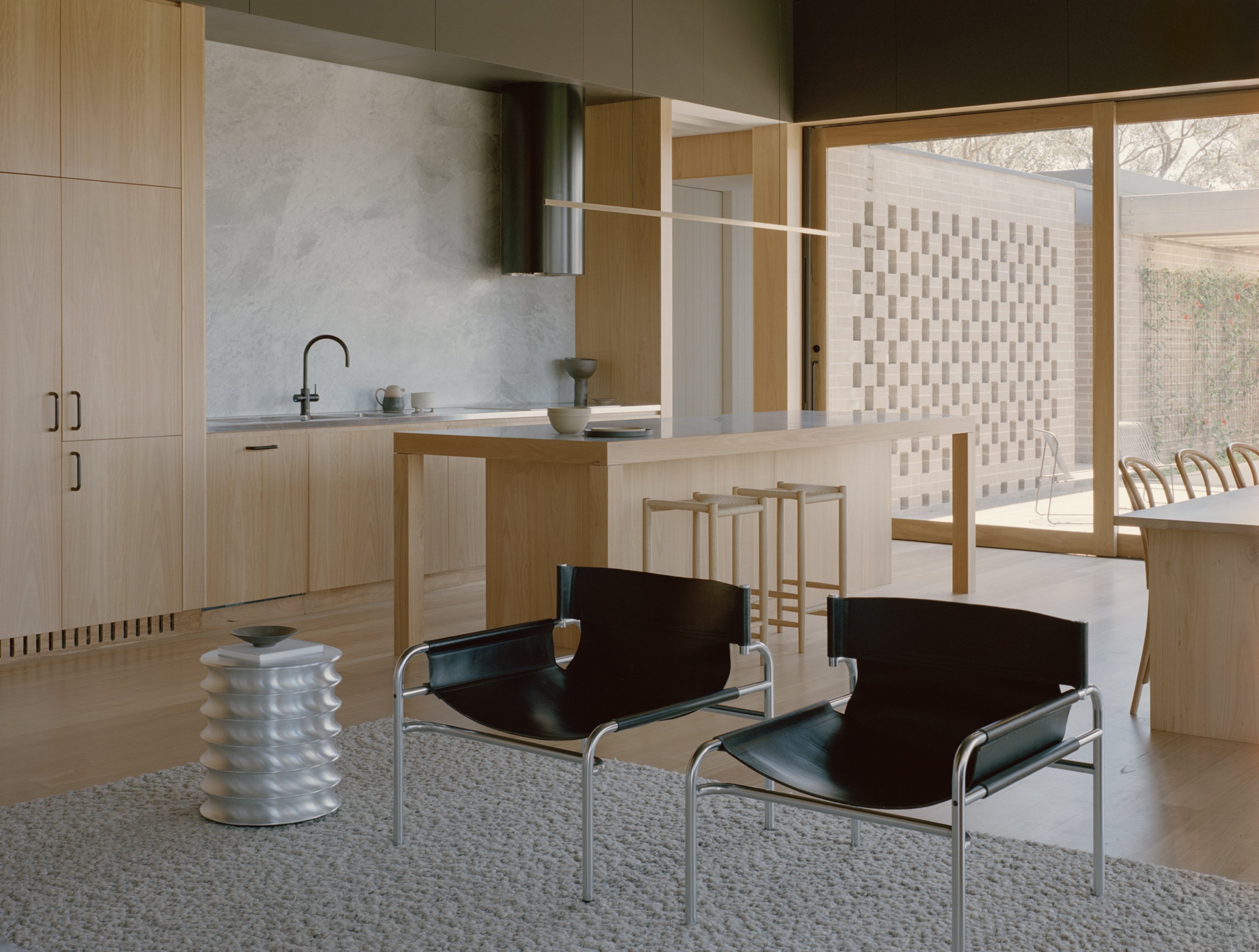 Living room with natural materials and warm neutral furniture.