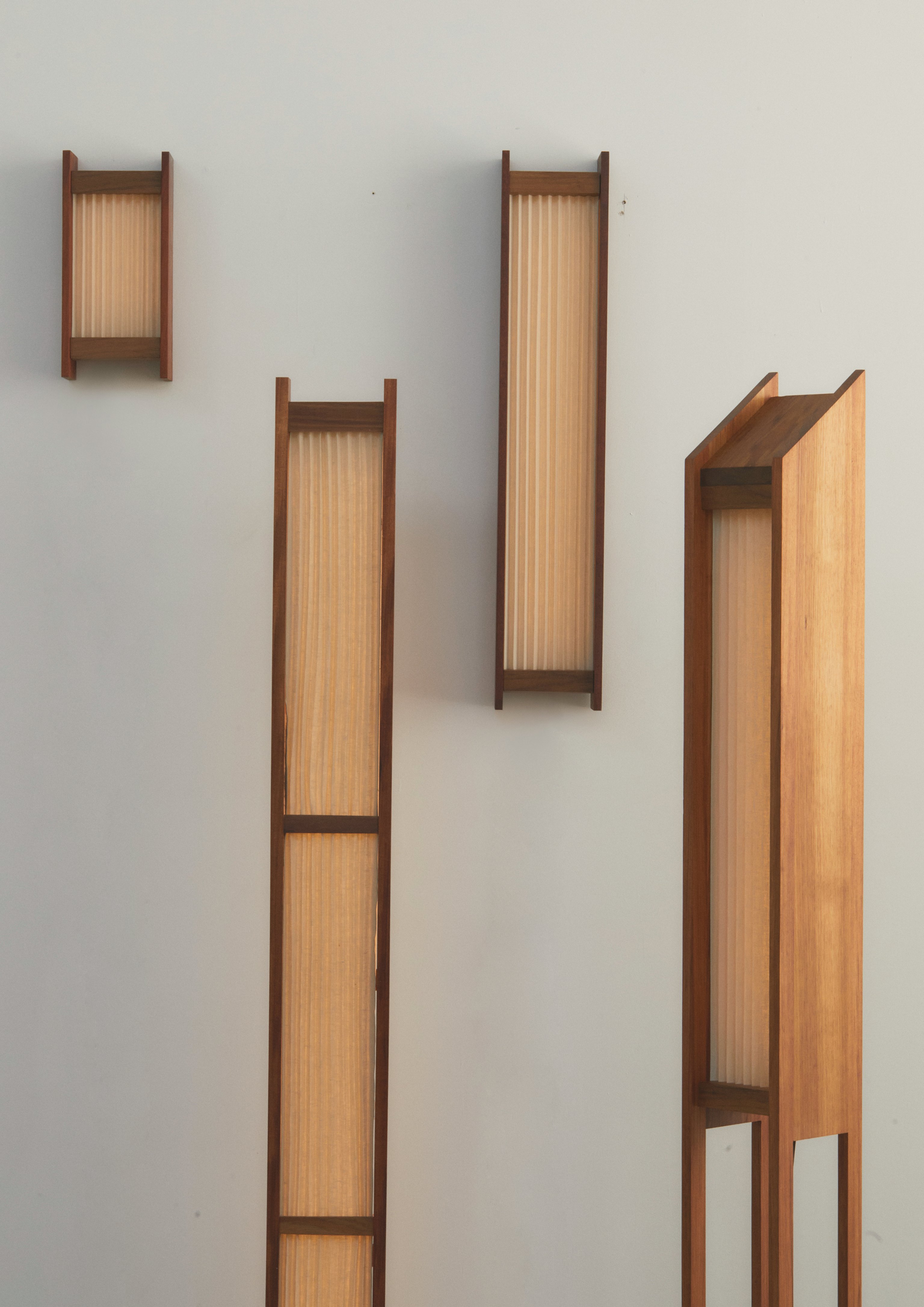 Wall lights and floor lamps with timber frames and pleated linen diffusers