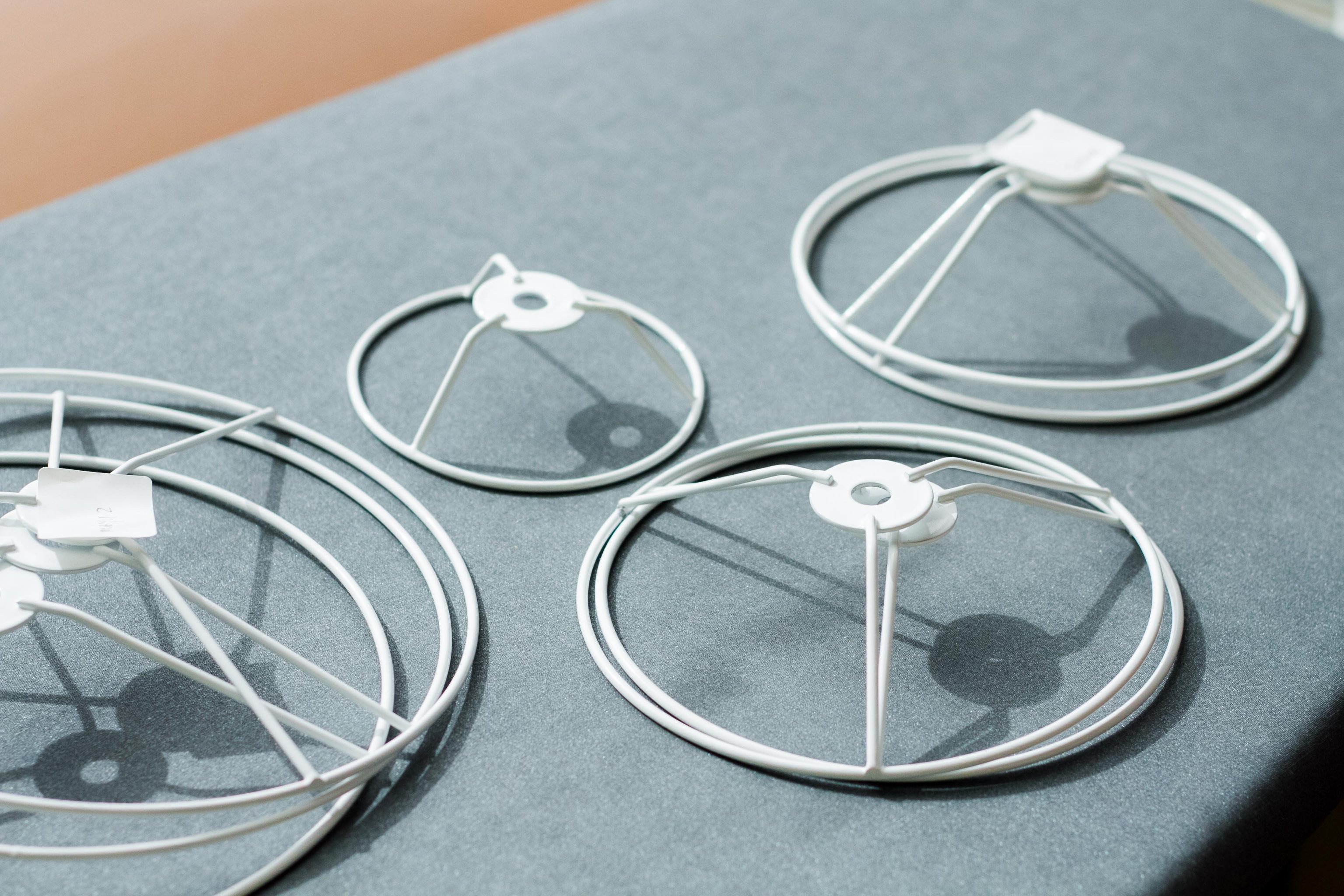 A set of Mayu wire frames sitting on a blue table top