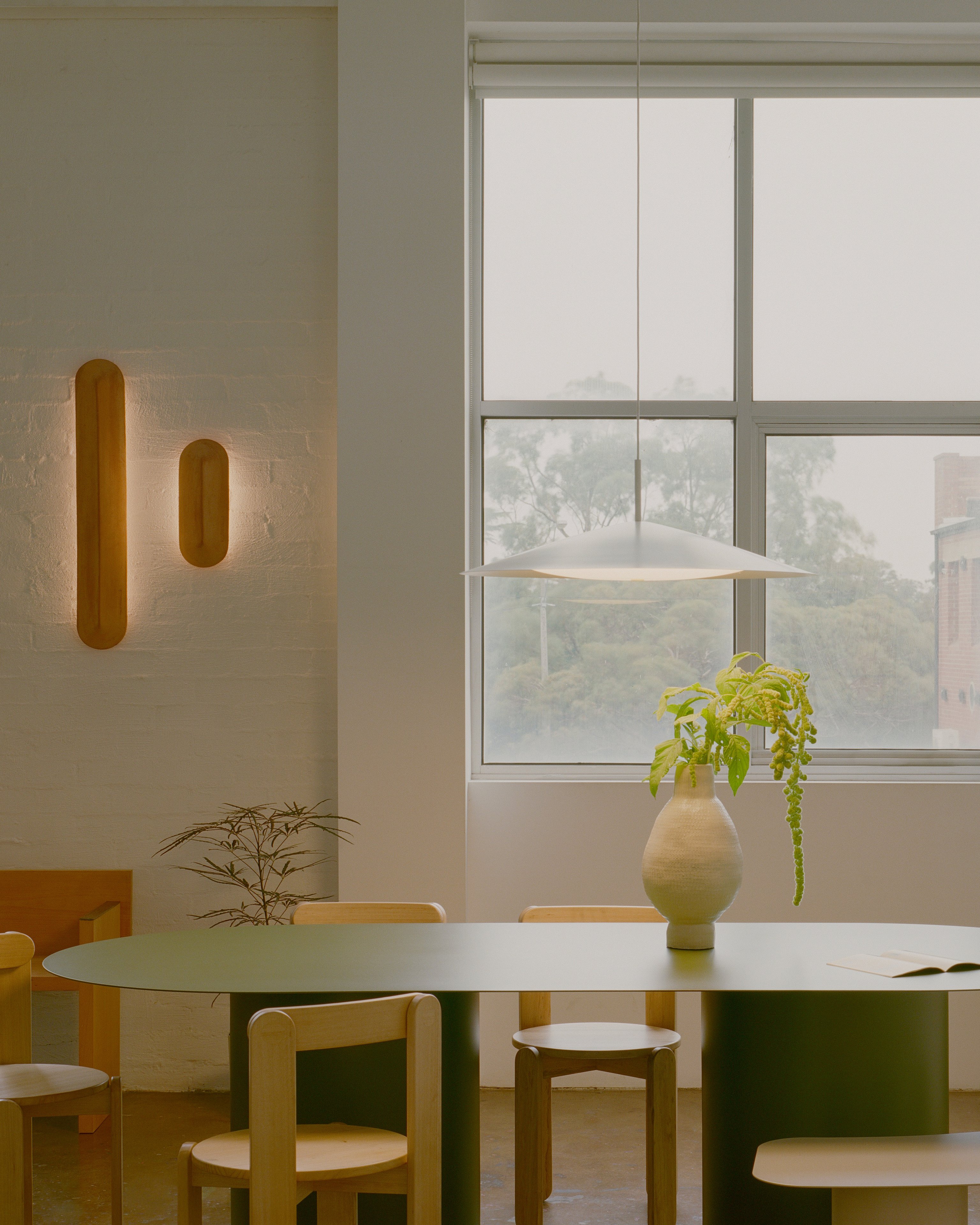 Pinch 400 and Pinch 900 Terracotta wall lights fitted to a white brick wall in the Coco Flip showroom