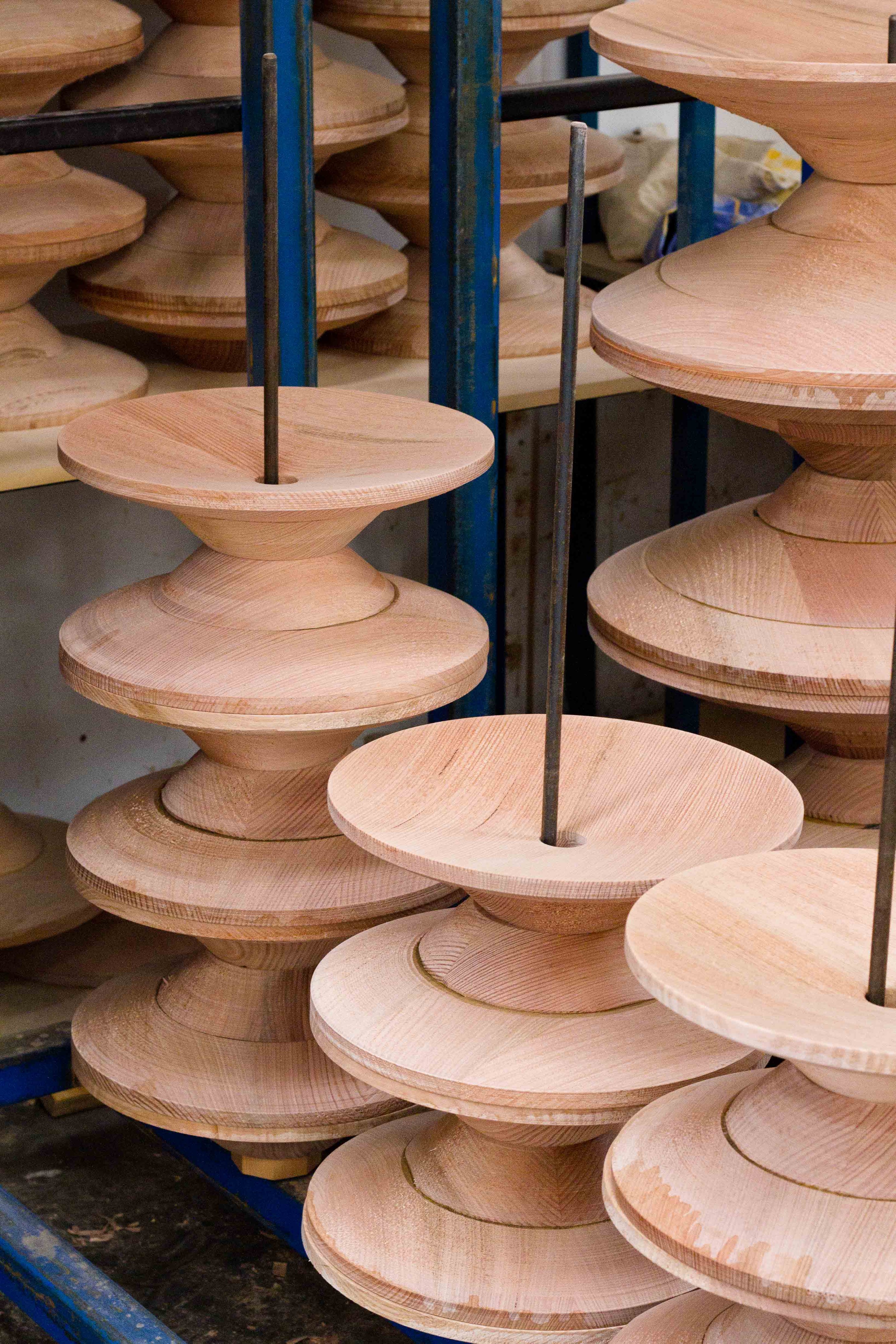 A stack of laminated timber forms on rods.