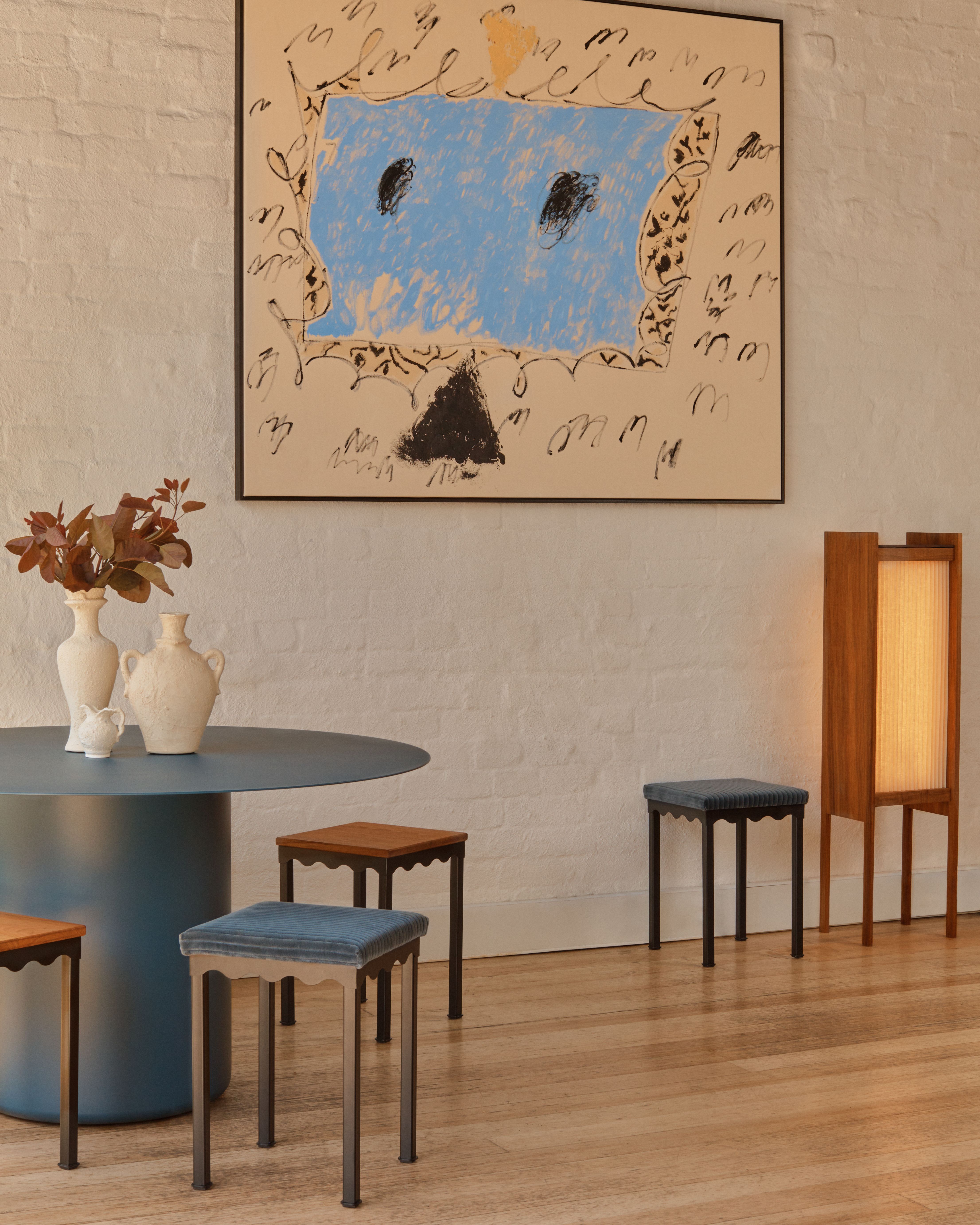 Coco Flip's Bellini stools around a Sequence Round Dining Table with a large modern artwork on the white brick wall.