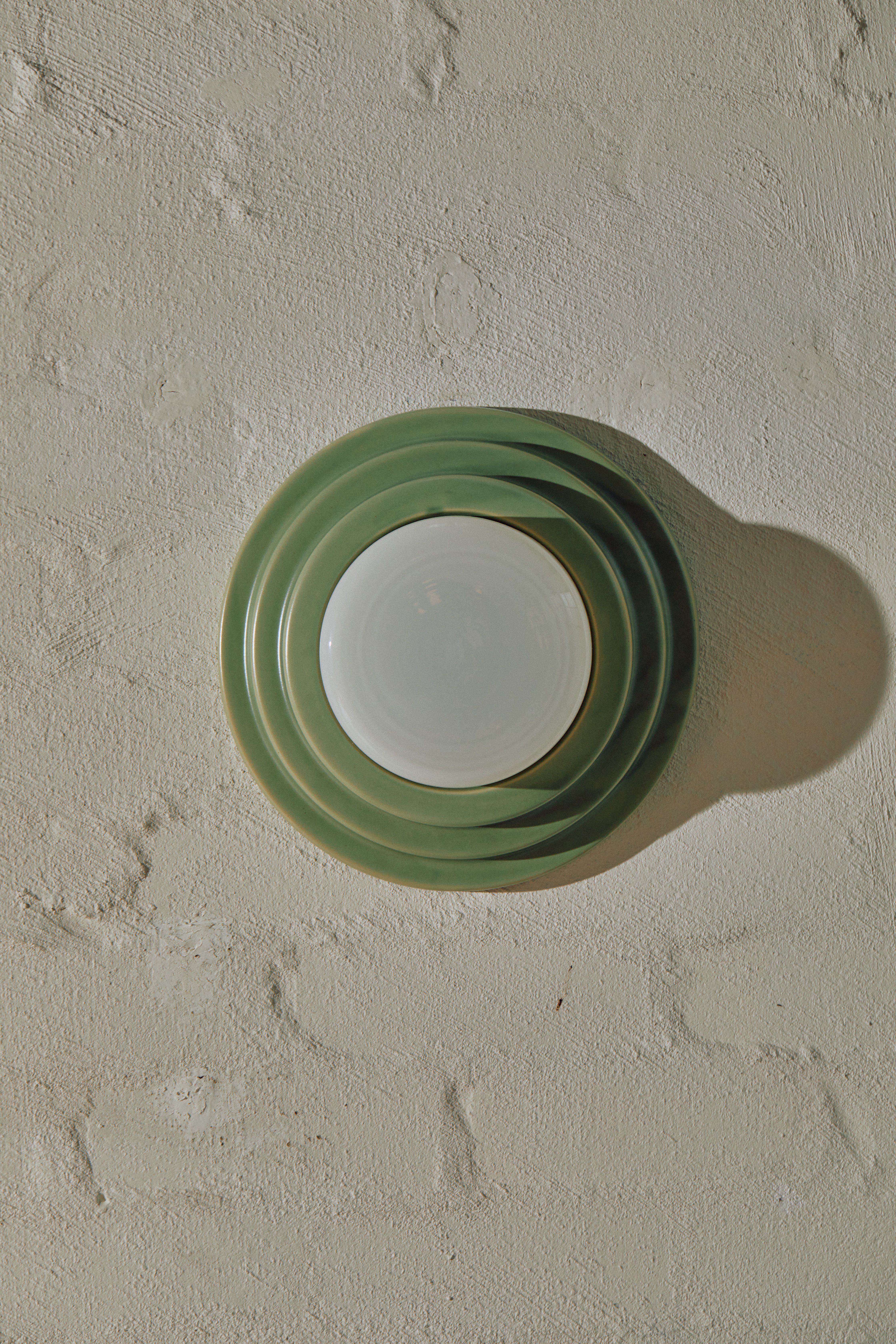 Green Honey Wall Light with tiered slip-cast ceramic base and hand-blown glass diffuser