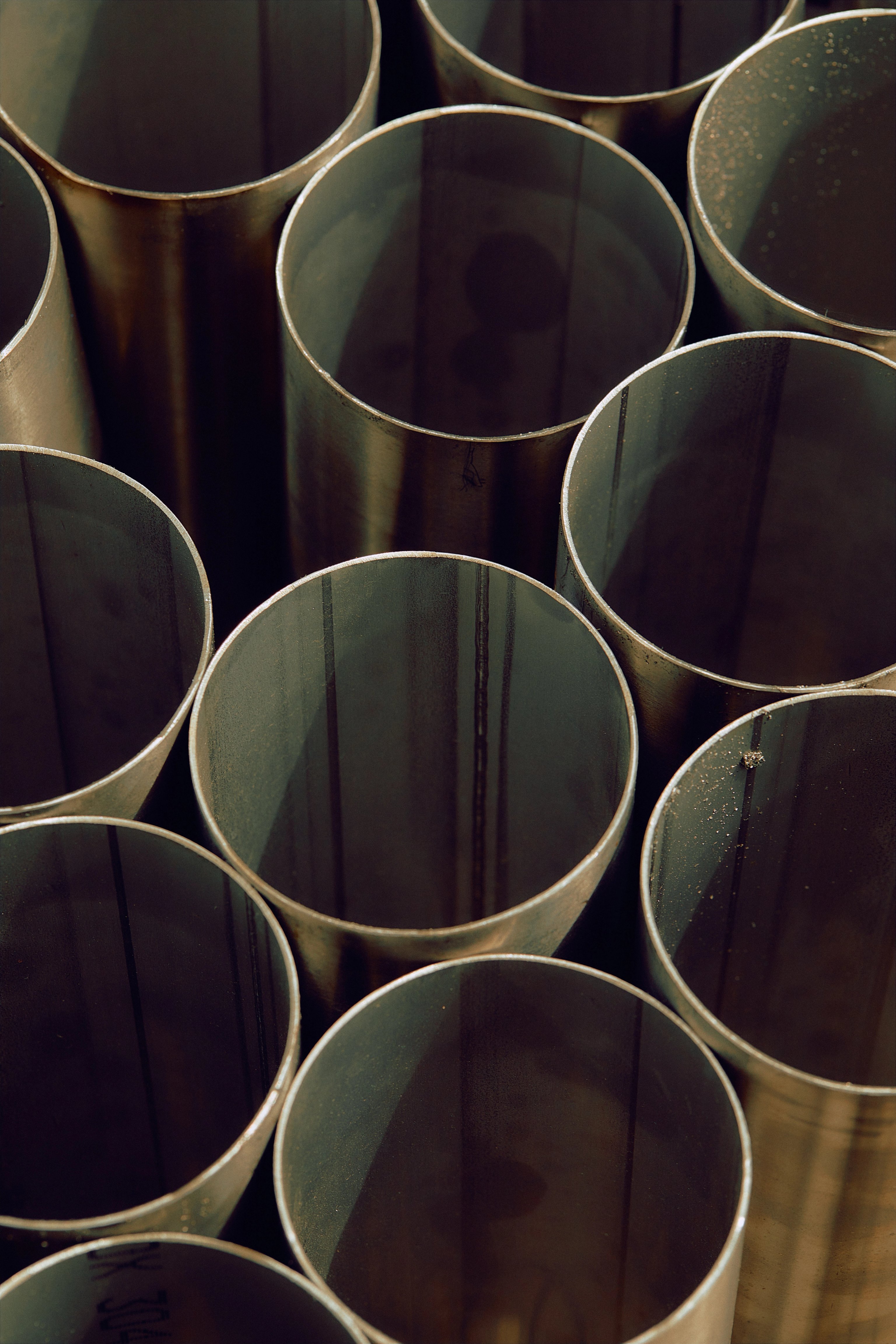 A group of metal tubes lined up next to each other, pictured from above