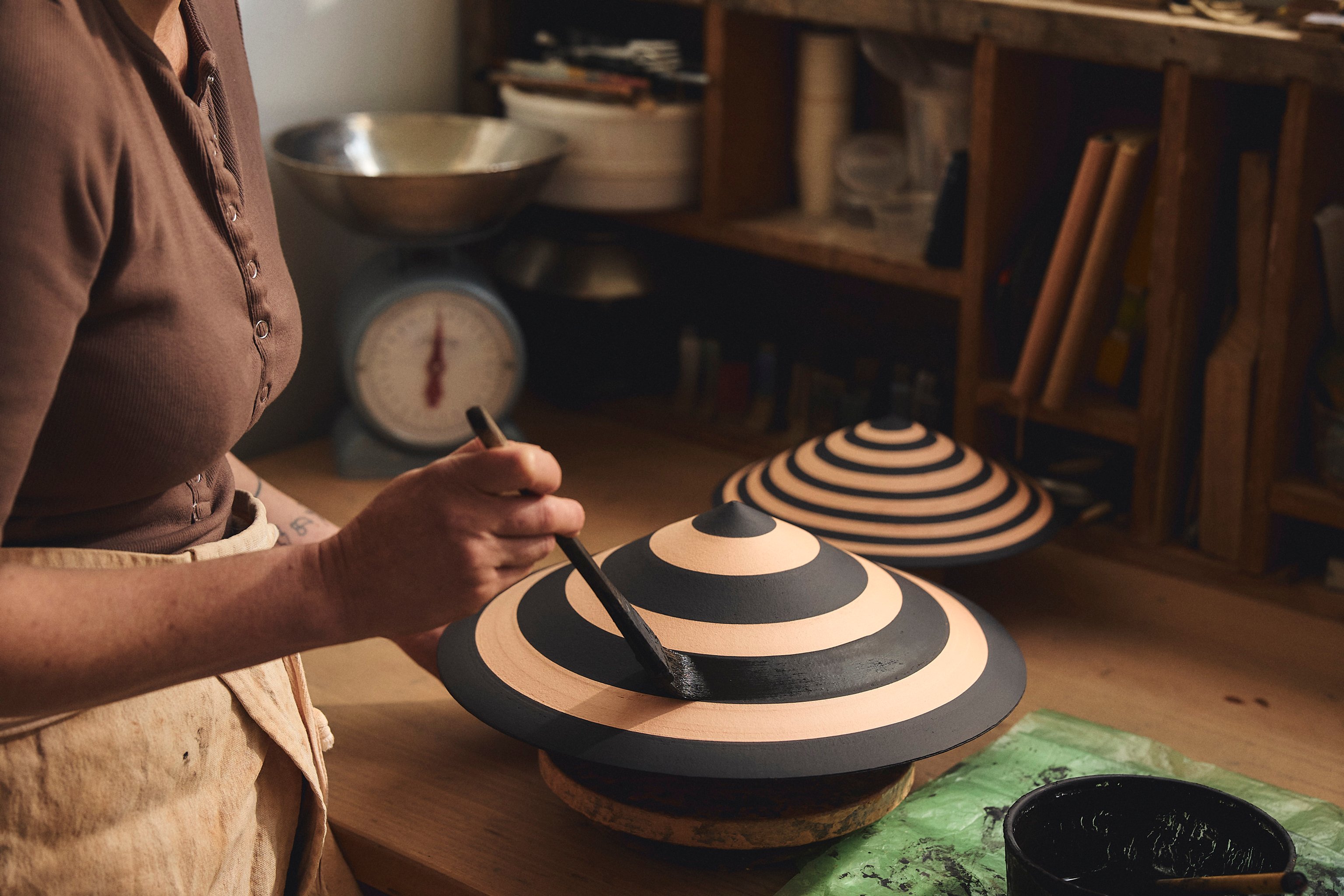 Belinda Wiltshire painting black stripes on a Dancer lampshade