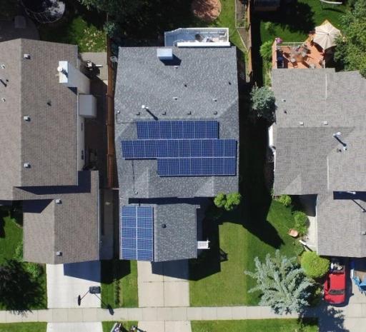 An aerial view of a home with solar panels on the roof