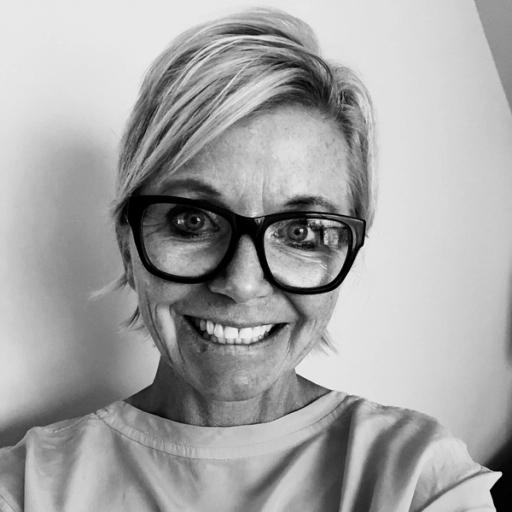 Headshot of woman in black and white on a white backdrop