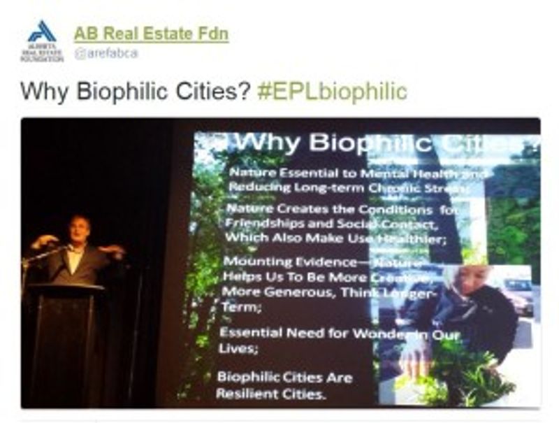 A person presents near a screen reading 'Why Biophilic Cities?'