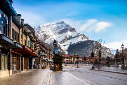 A long line of shops and buildings along a street in a mountain town