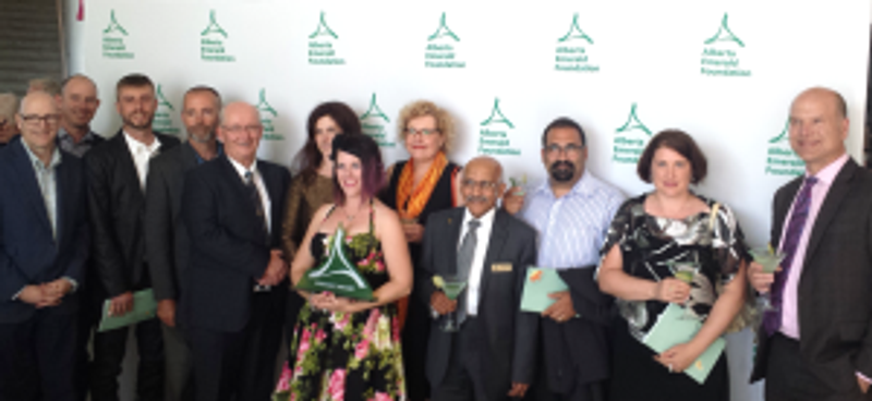 A group of people take a photograph in front of a photo booth for Alberta Emerald Foundation