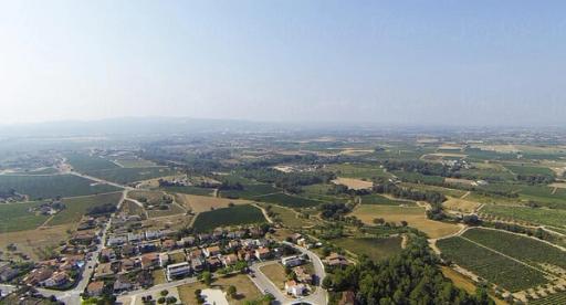 An aerial view of a community with a hazy blue sky above.