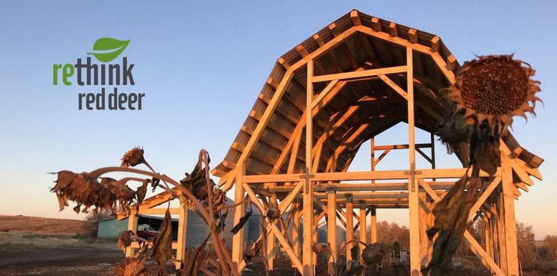 Barn frame with logo for Rethink Red Deer in the foreground