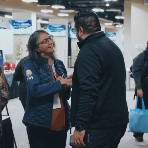 Two people shake hands at a career event