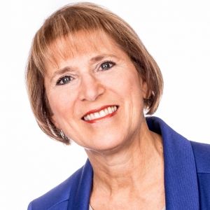 Headshot of Christine against a white backdrop