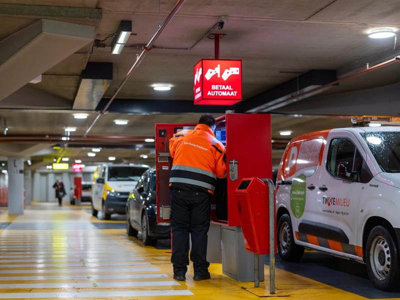 Medewerker parkeerbeheer controleert betaalautomaat