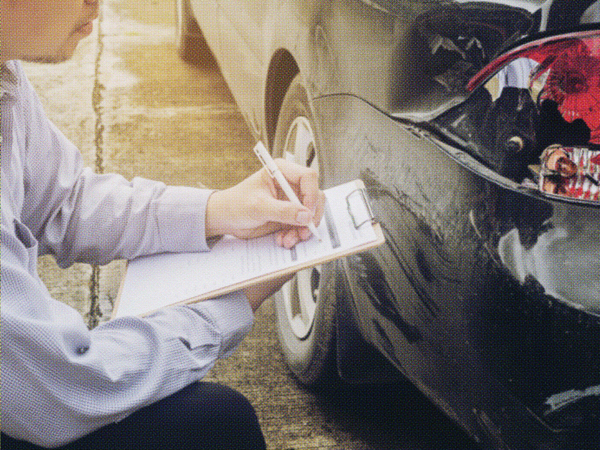 insurance worker appraising damage to a car