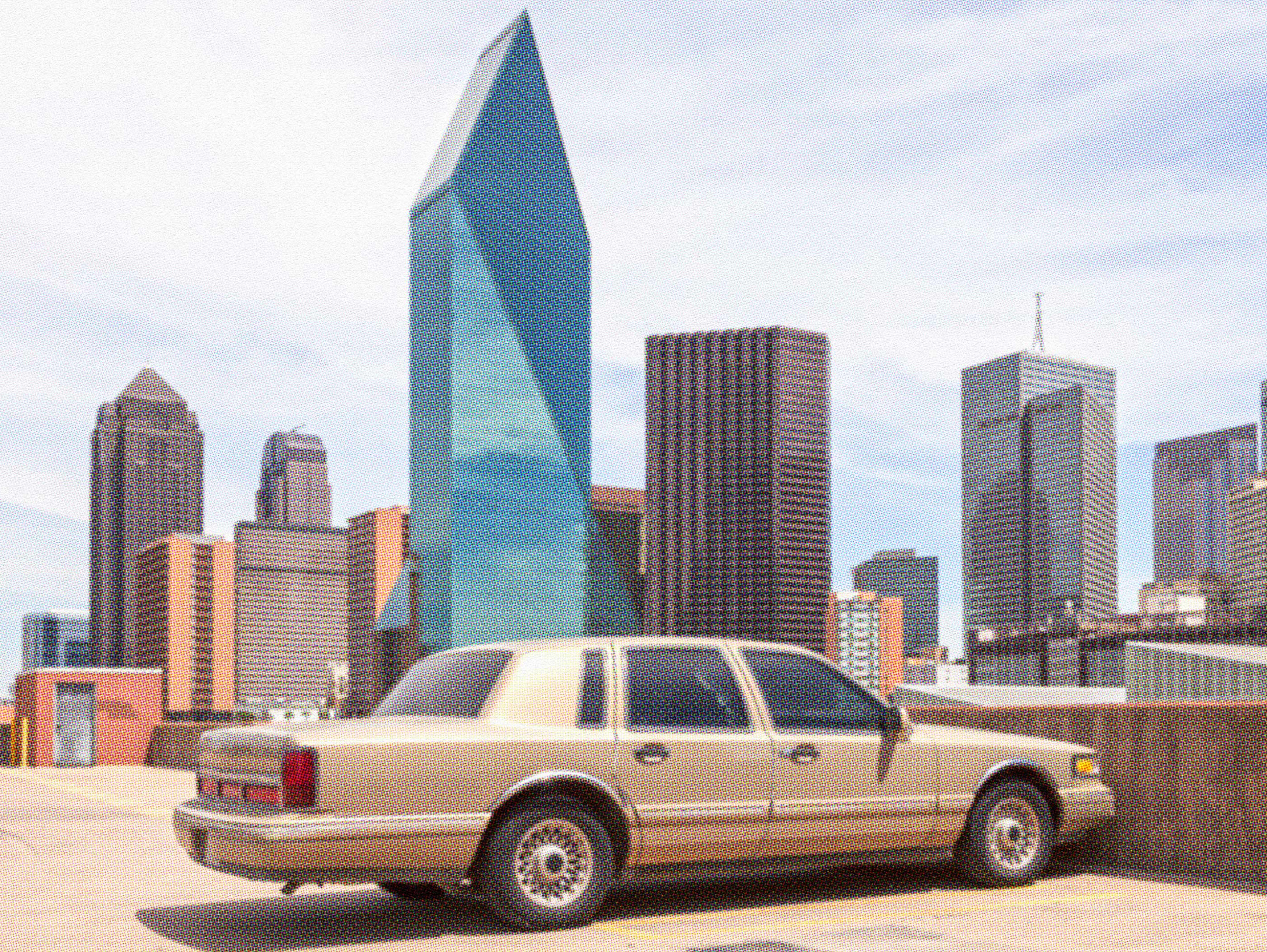 Beige sedan parked in front of a city skyline, representing selling a car before moving out of state.