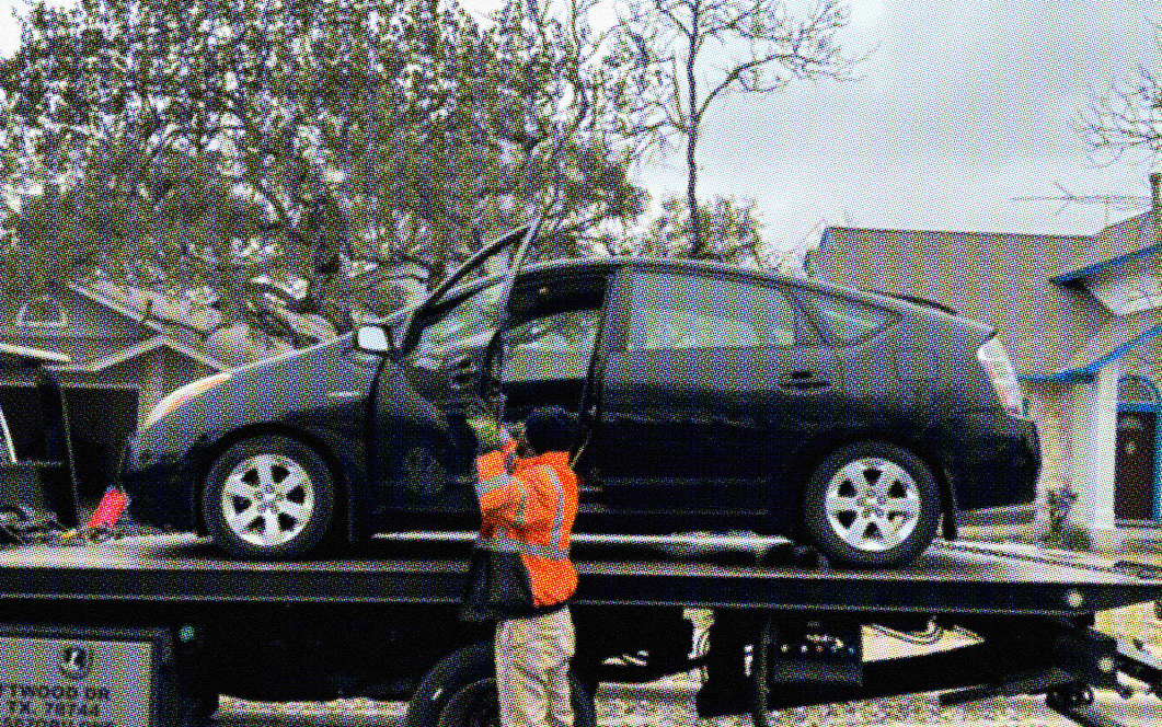 black car on tow truck