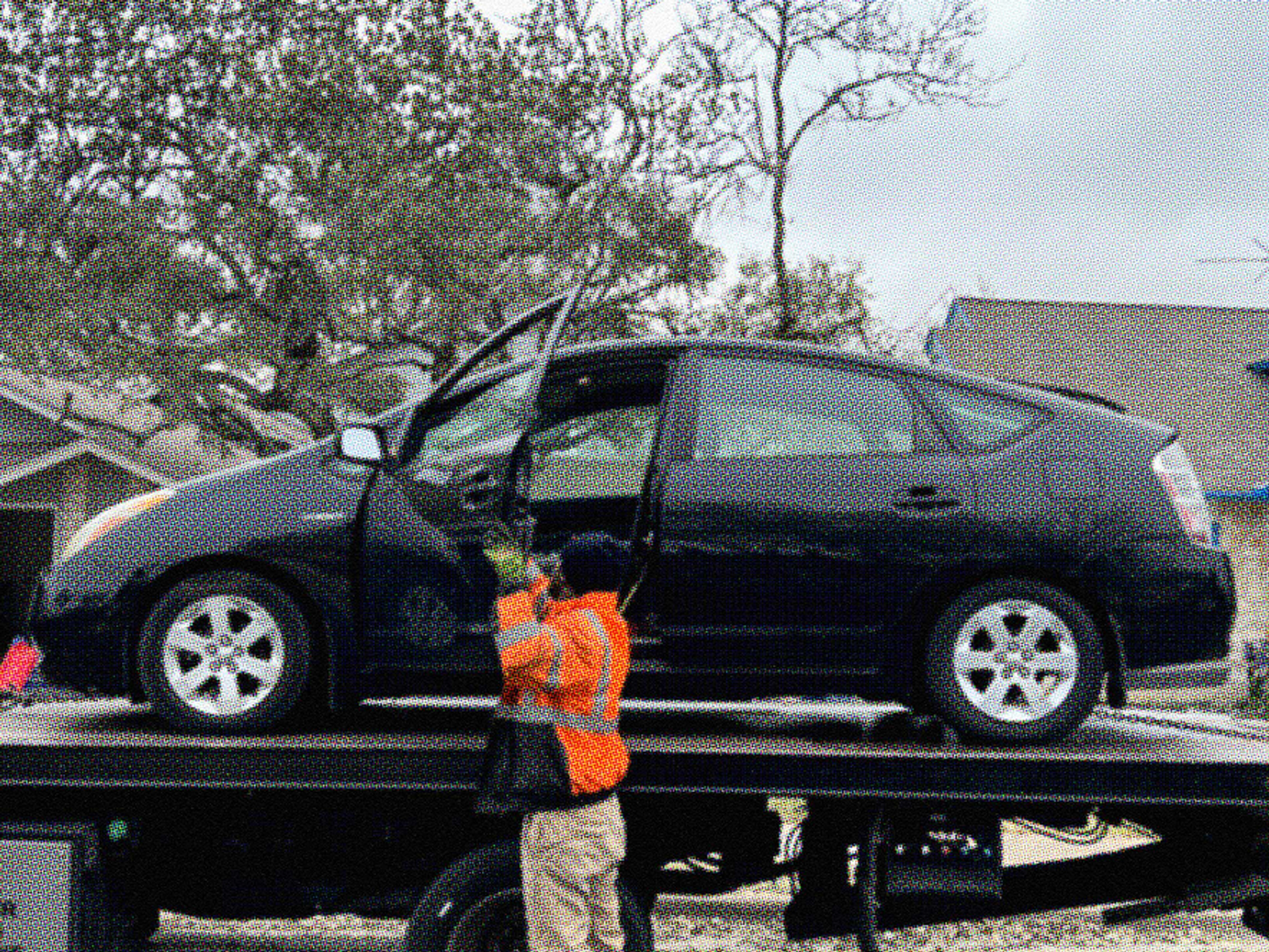 black car on tow truck