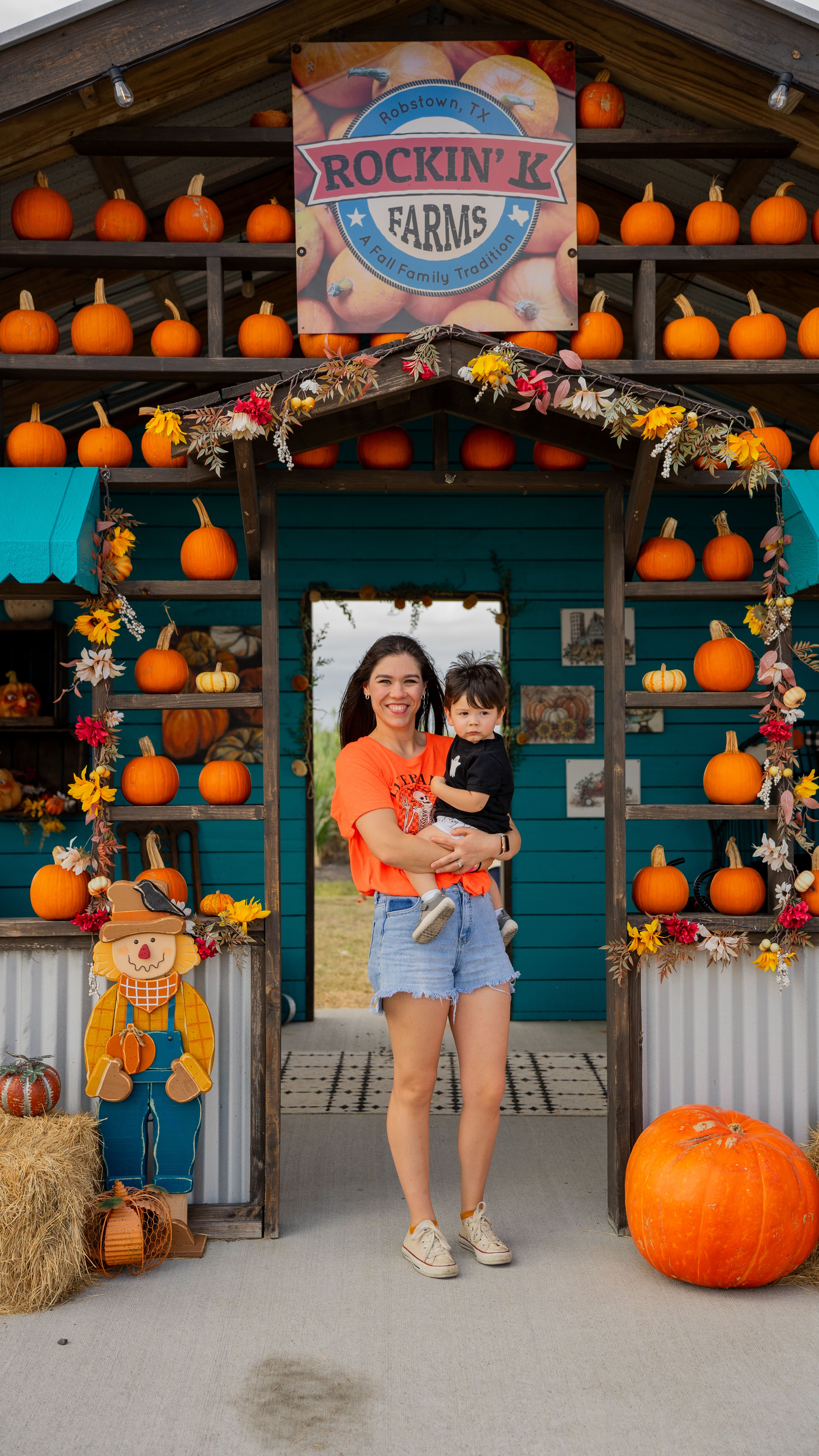 Child and mother under a pumpkin area
