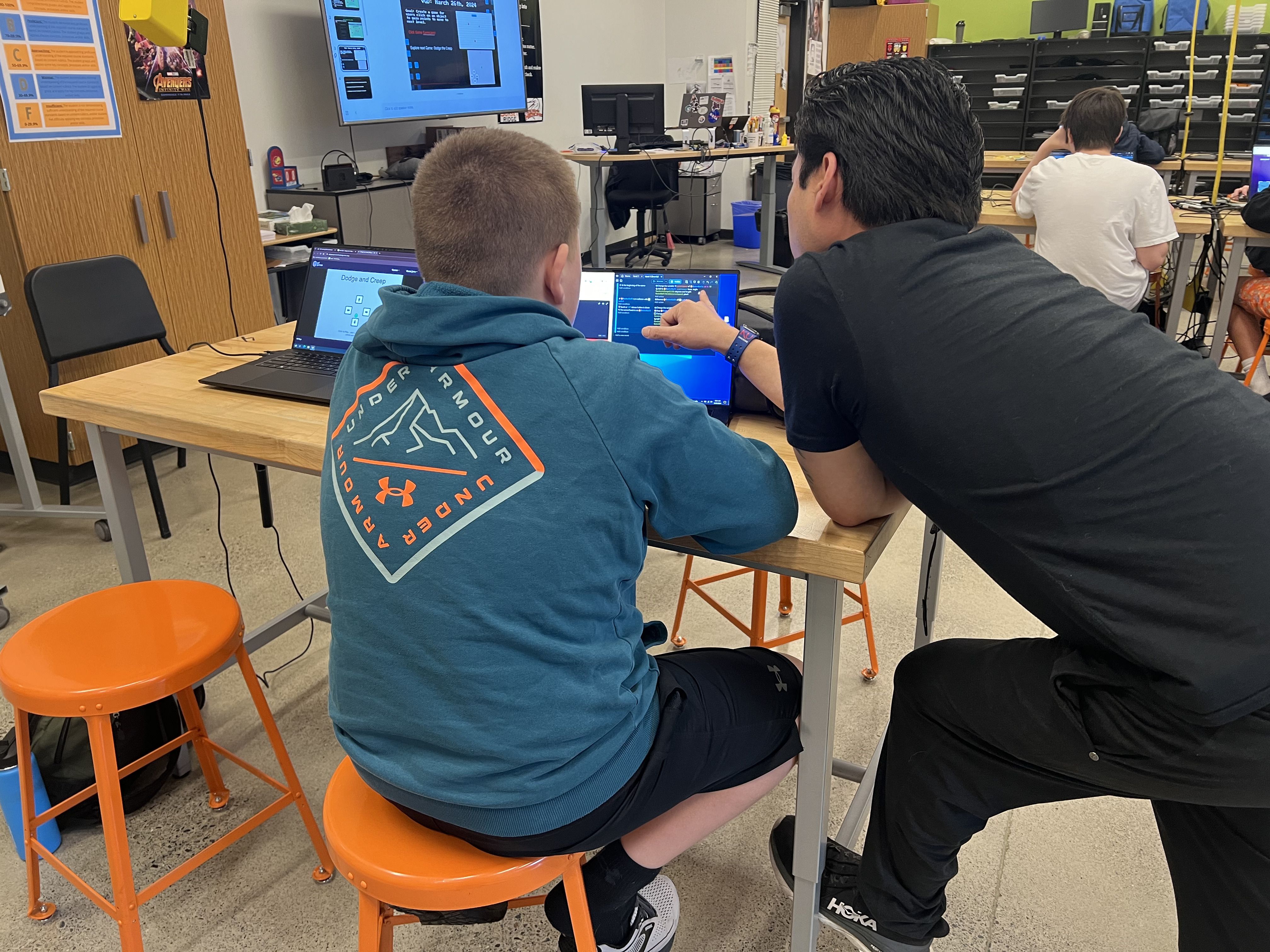 Nam assisting a student during the game design process with GDevelop. 