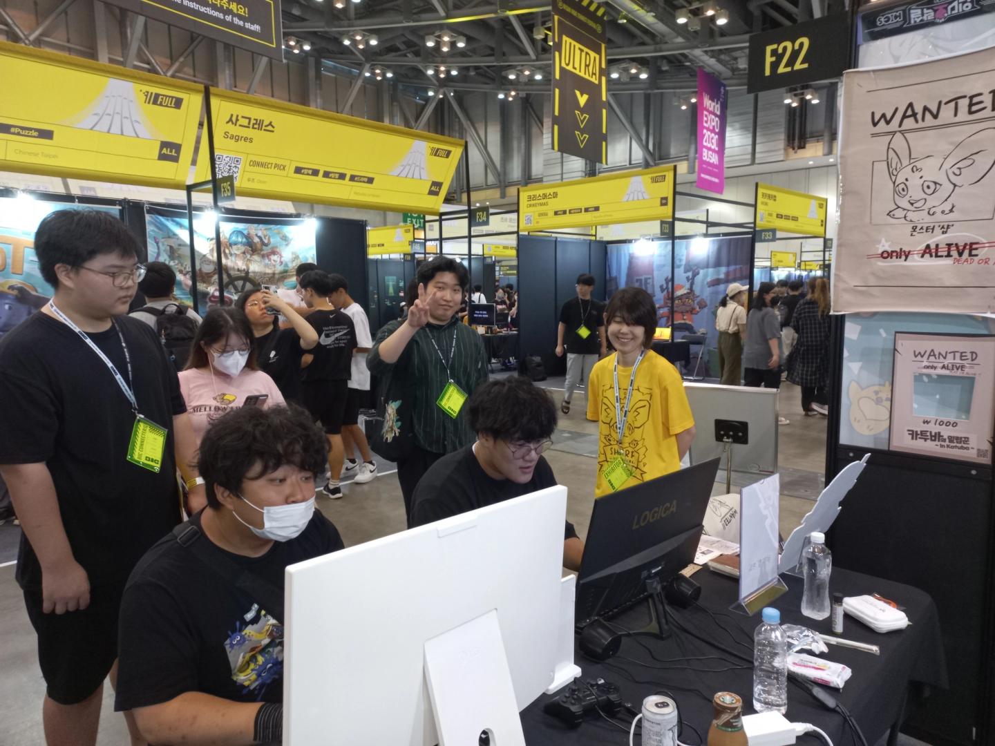 The Katuba's Poacher team watching people play the game at Busan Indie Connect.