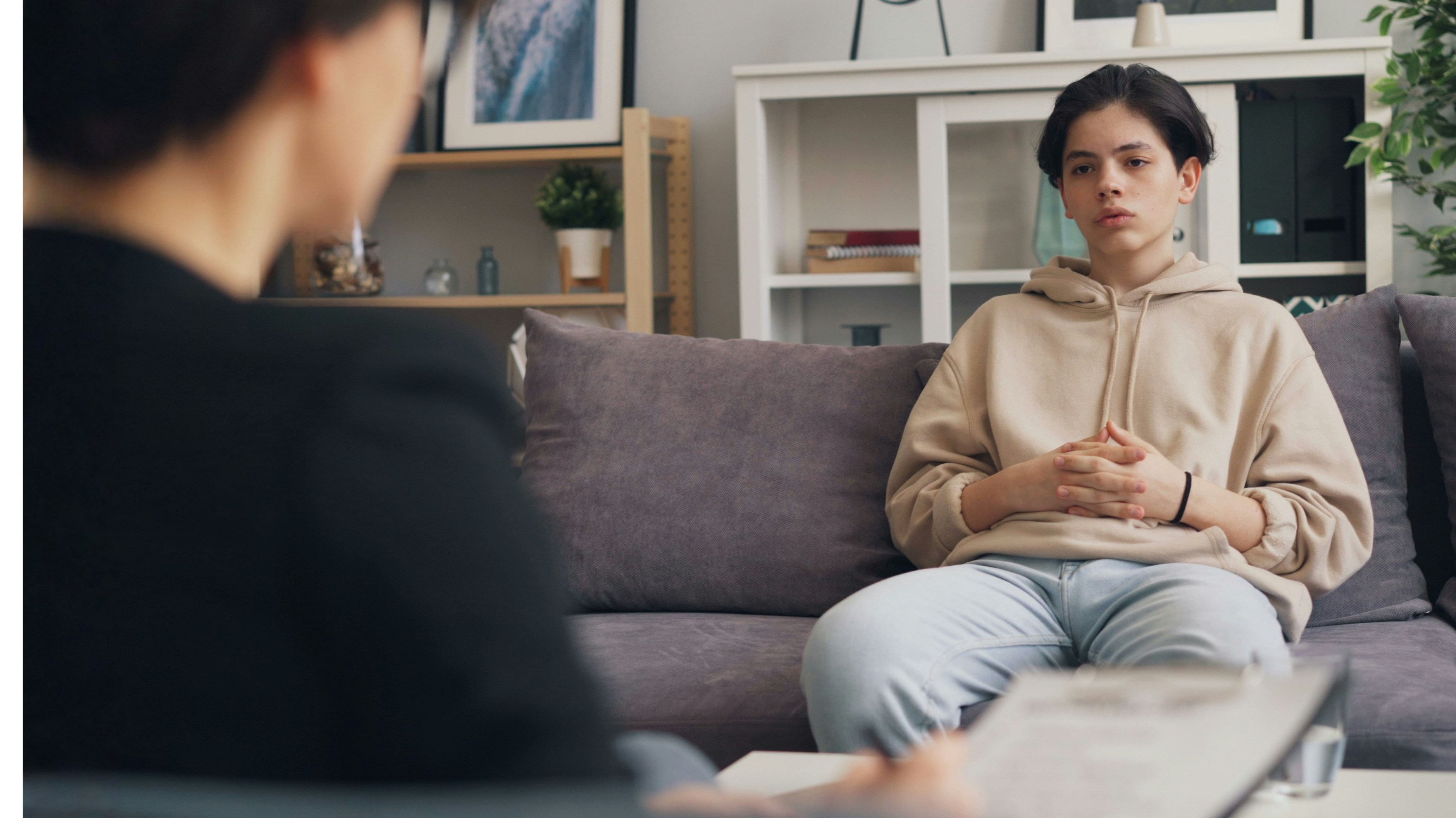 Teen sitting on a couch getting mental health support