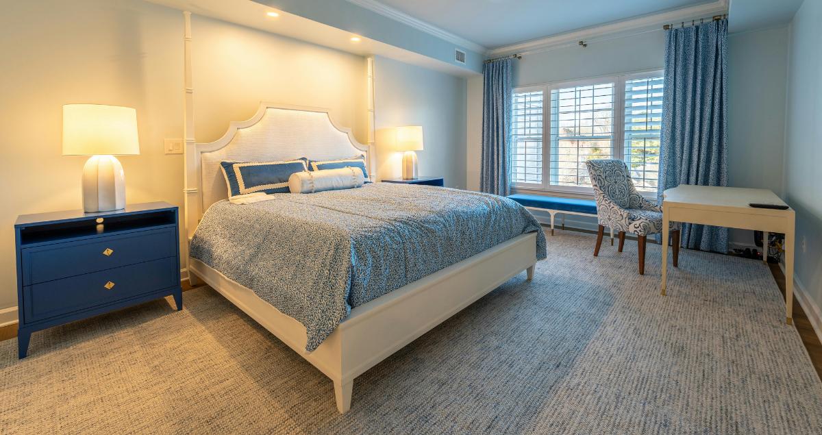Comfortable blue bedroom inside a private TDY home rental for Air Force pilots with TDY Hero
