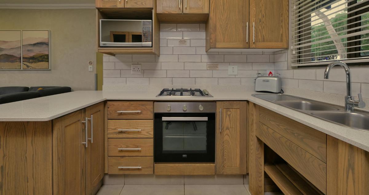 Modern marble kitchen in a furnished rental highlighting quality accommodations eligible for off base lodging reimbursement
