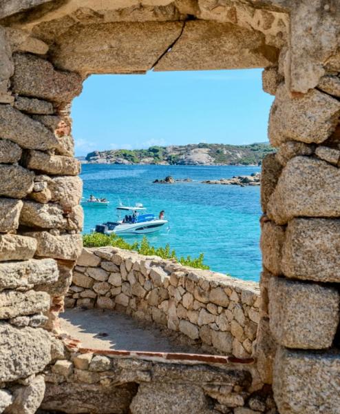 A view of a motorboat on turquoise water in Porto Cervo, Sardinia