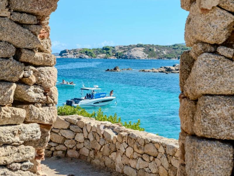 A view of a motorboat on turquoise water in Porto Cervo, Sardinia