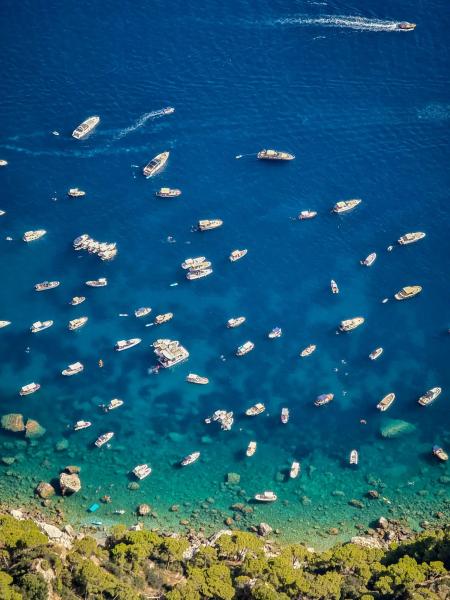 Blue water with many boats in a bay in Capri