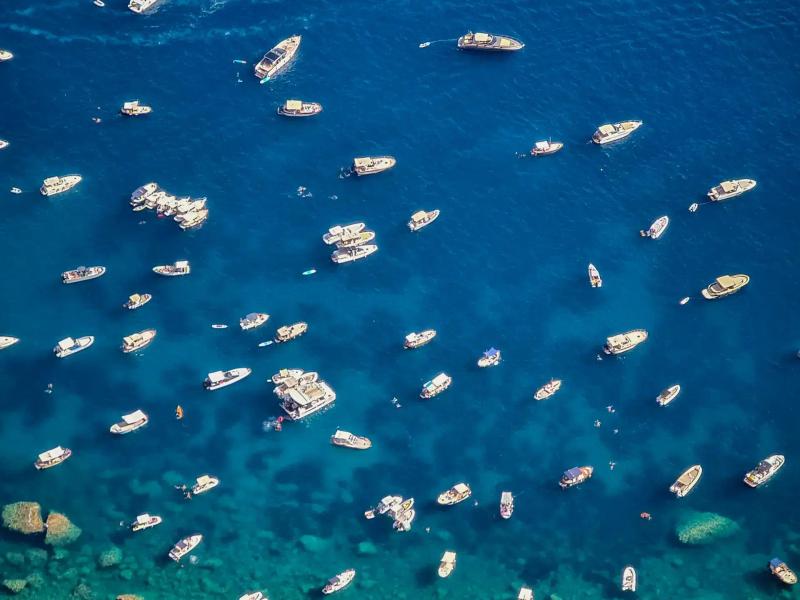 Blue water with many boats in a bay in Capri