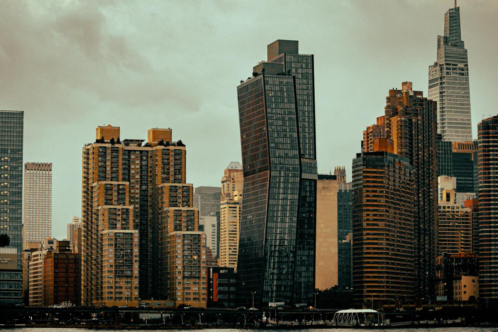 Dense high-rise skyline in muted tones beneath an overcast sky.