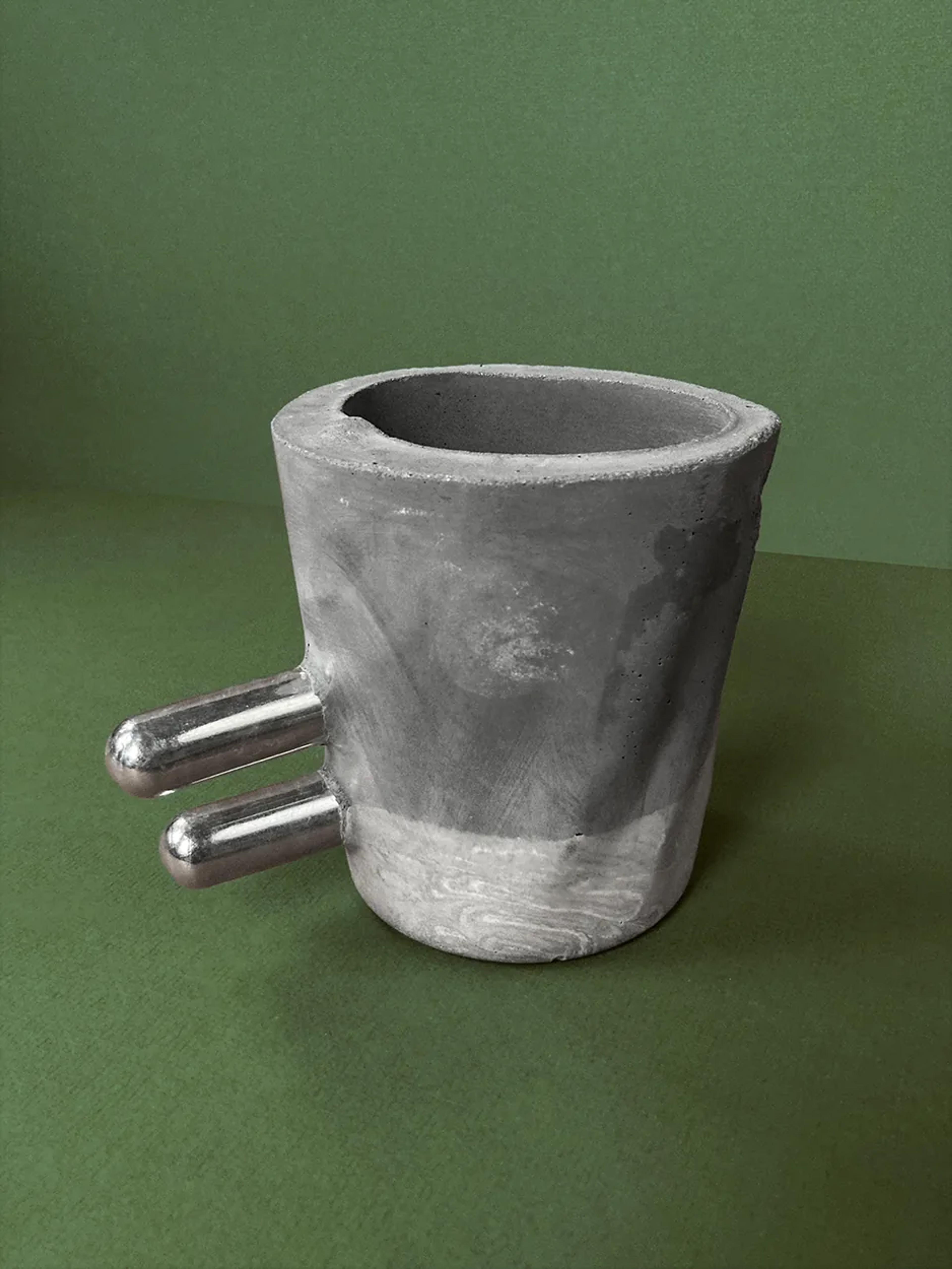 Make It Double — a concrete planter with two parallel chrome rods, unplanted, view 1 of 2