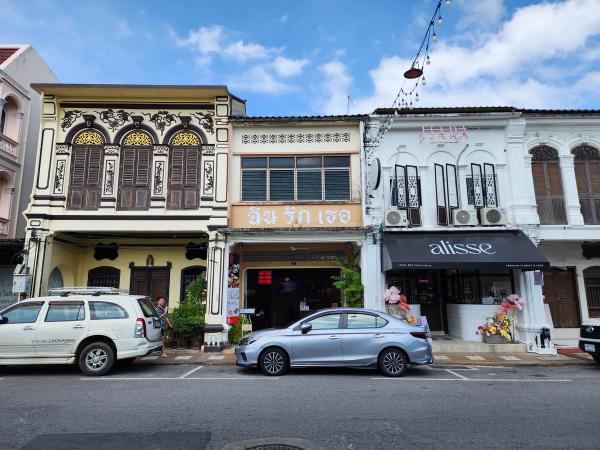 Sino-Portuguese shophouses on Thalang Road in Old Phuket Town in late-afternoon light.
