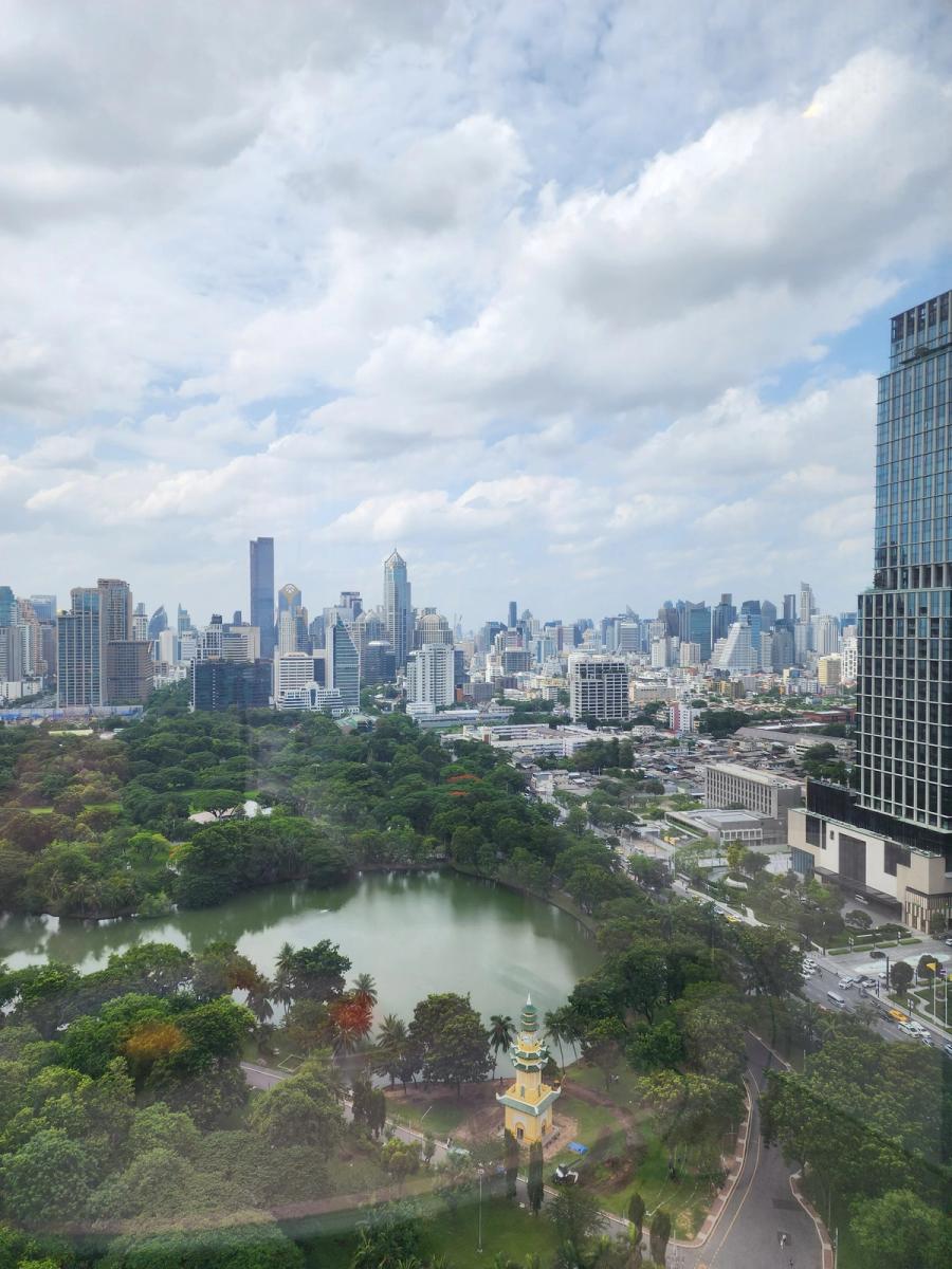 Lumphini Park lake and the Bangkok skyline seen from a hotel room window.