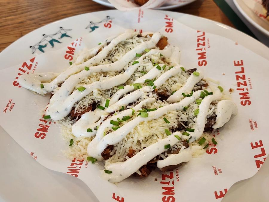 Crispy smashed potato under shredded cheese, sour cream sauce and spring onion.