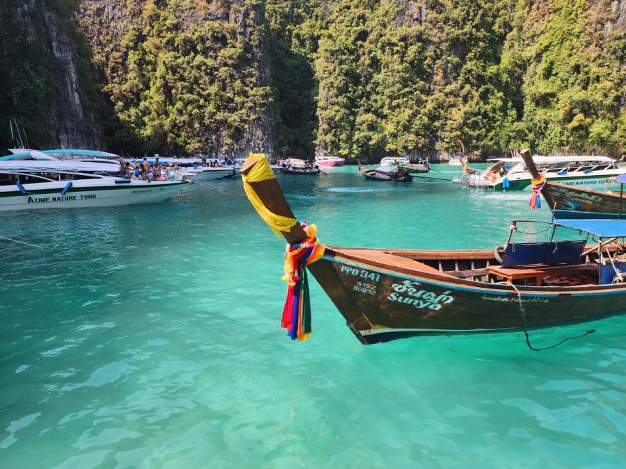 A longtail boat in clear blue water.
