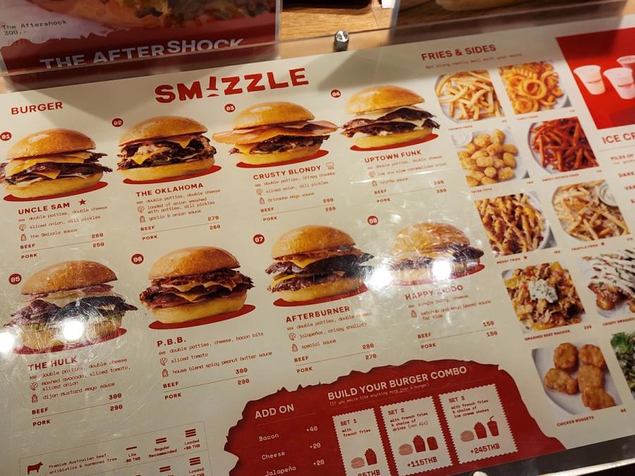The Smizzle menu board listing burgers with beef and pork prices alongside fries and sides.