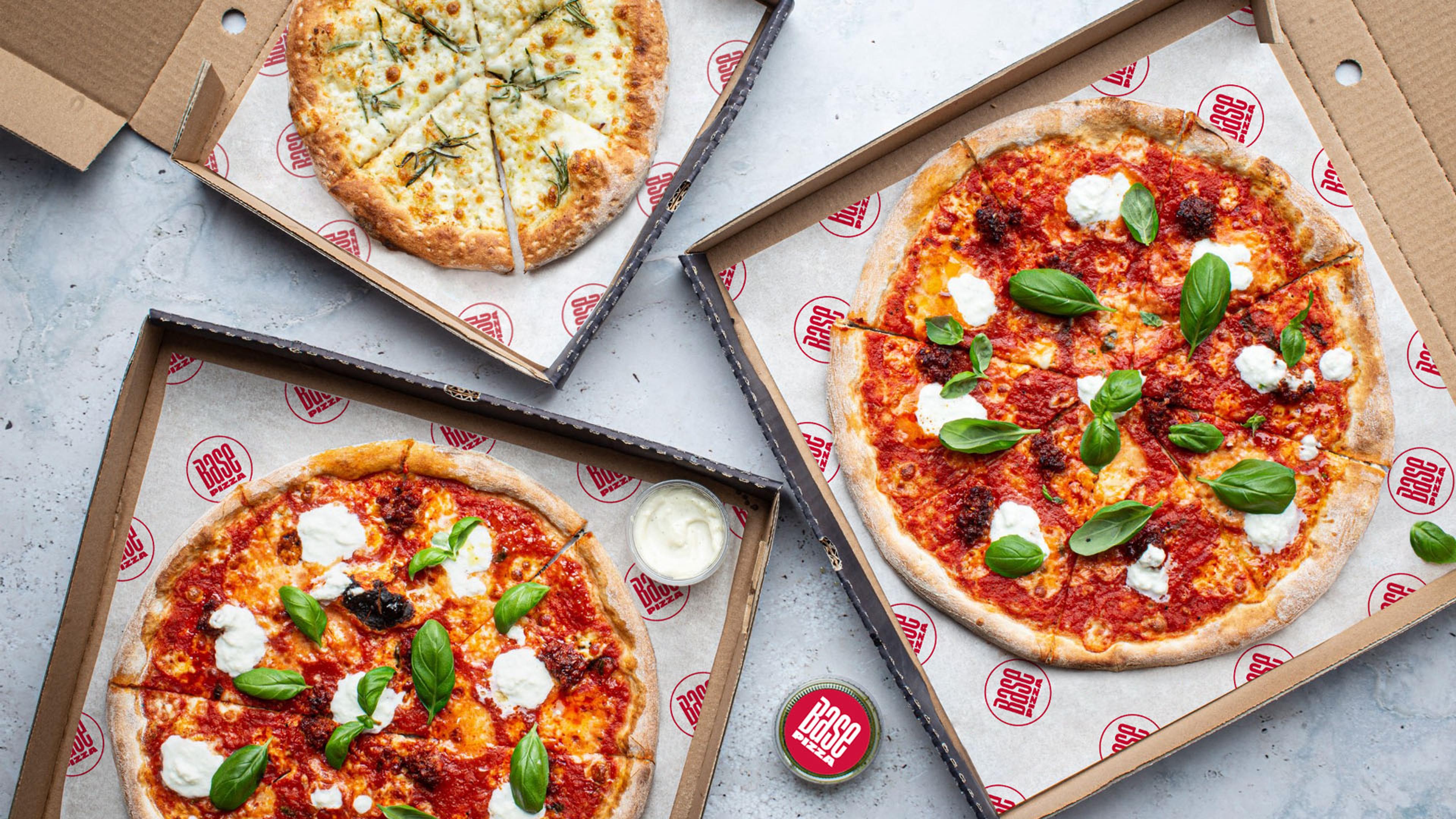 Several Base pizzas in open boxes