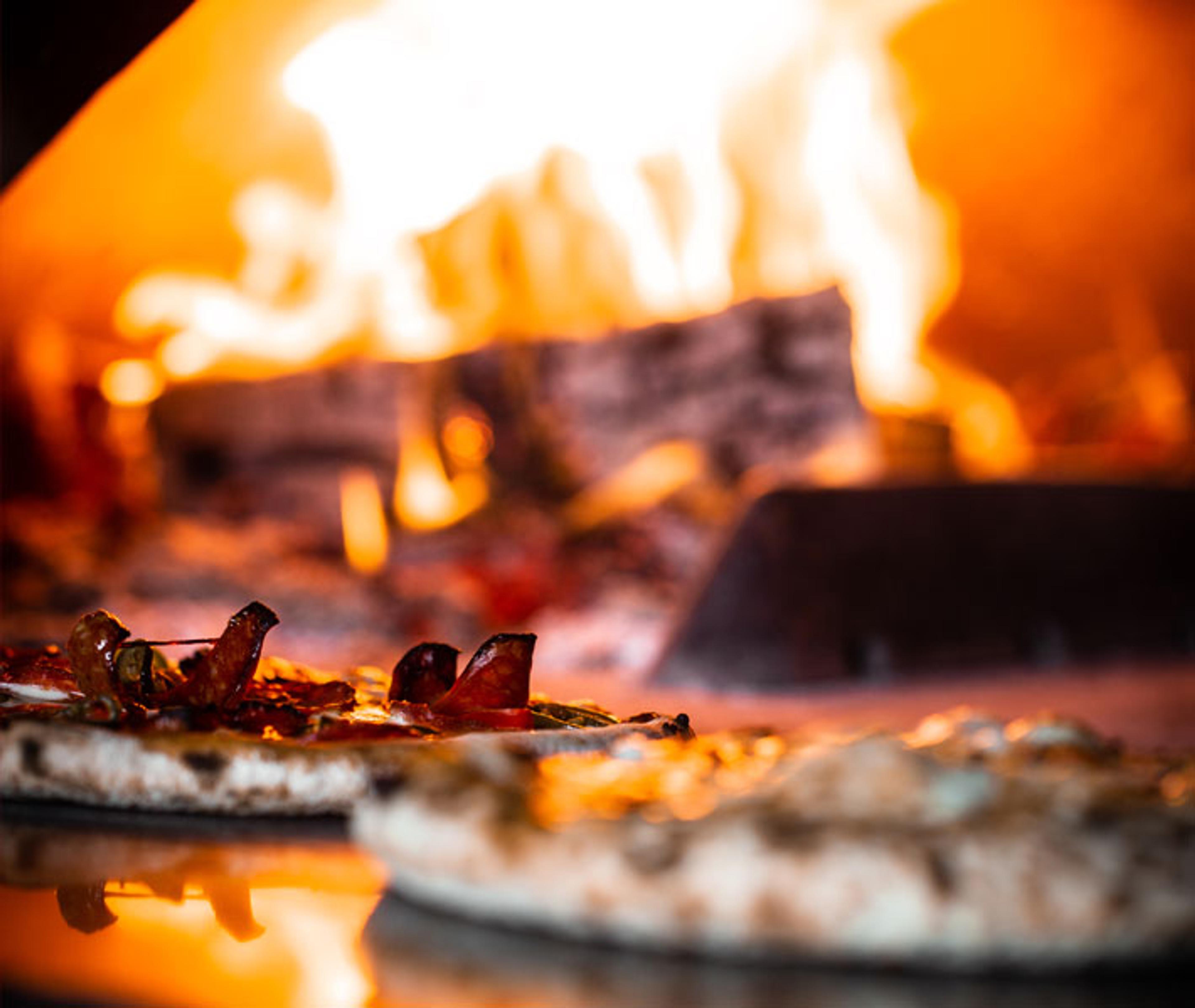Wood fire burning inside a pizza oven