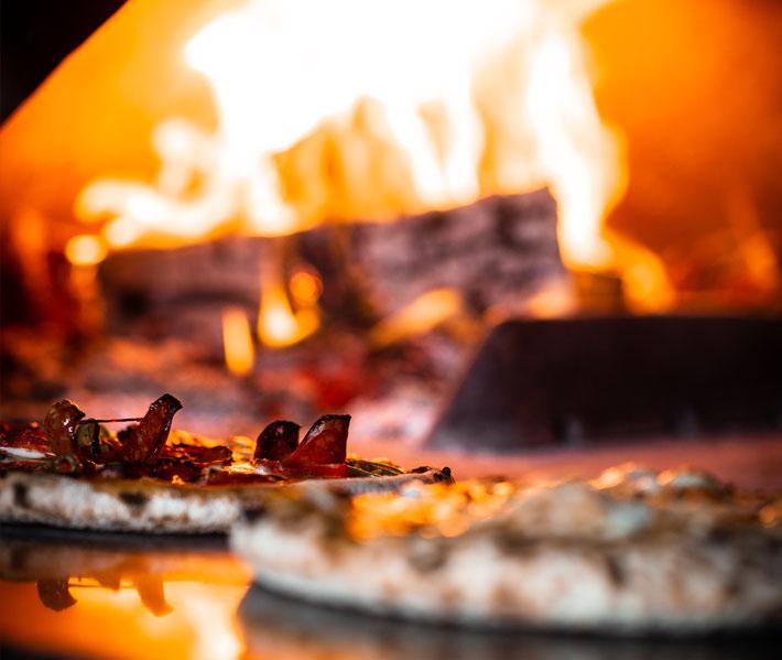 Wood fire burning inside a pizza oven