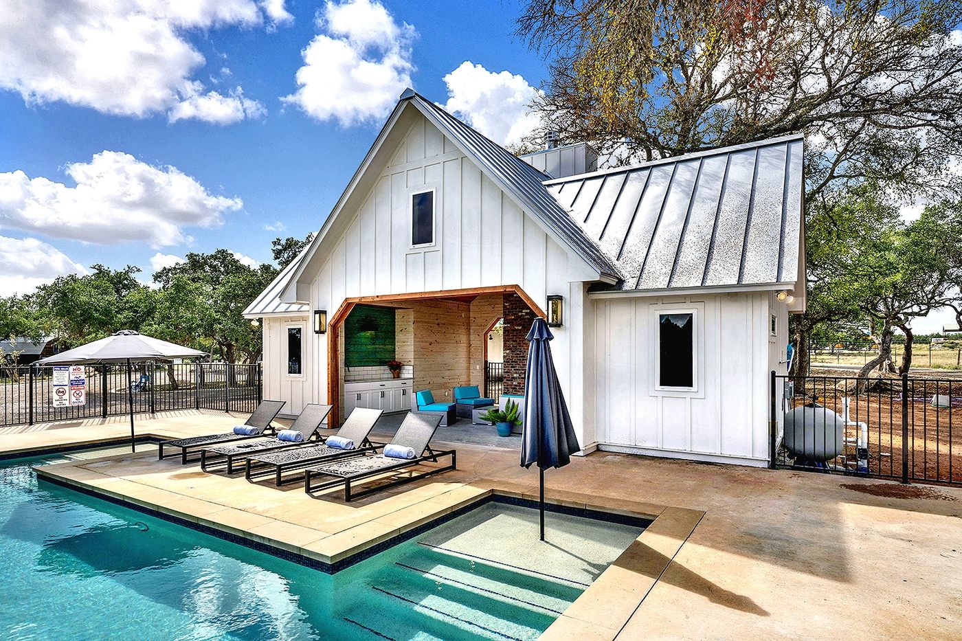 The pool, pavilion, and stone fireplace at Wayside Wimberley